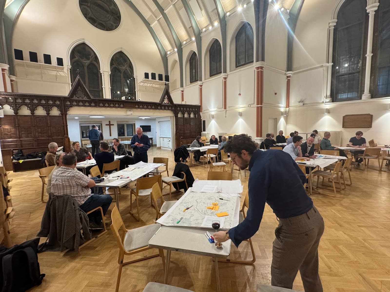 Workshop participants gathered around tables in the church hall