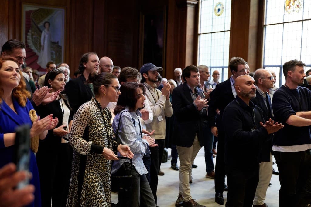 Attendees applauding during speeches
